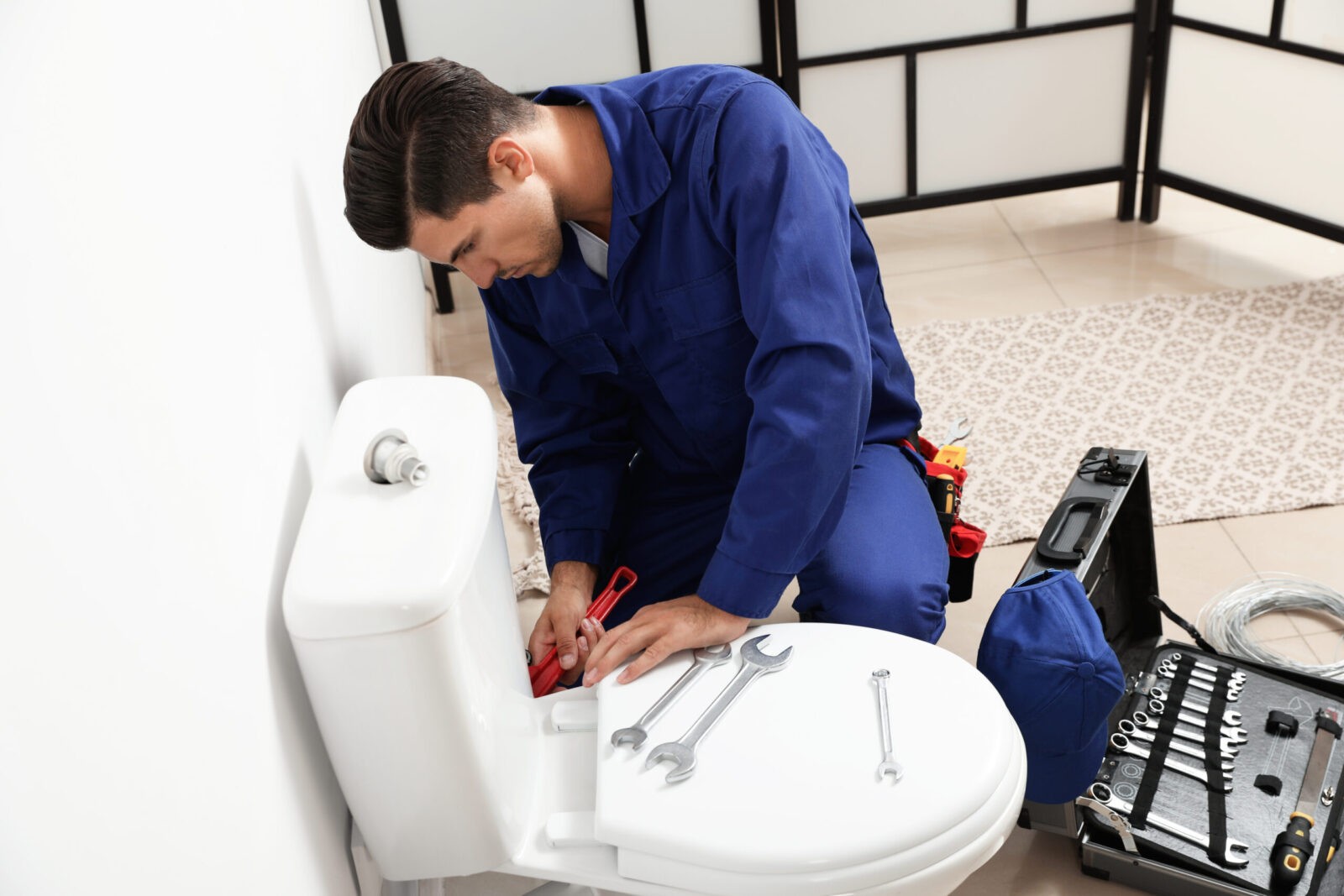 Plumber in Katy, TX completing a residential toilet installation.